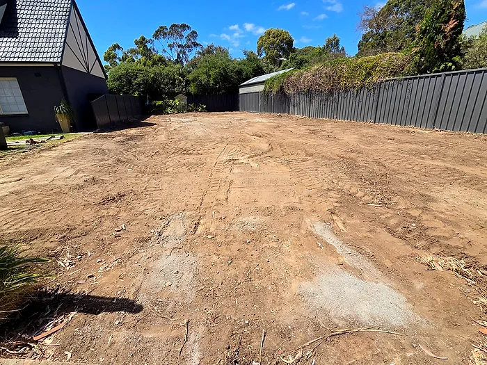 A cleared and levelled area where a concrete driveway was removed