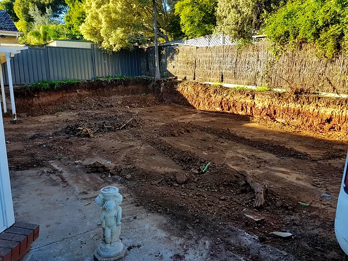 A side yard excavated and graded into an extra parking bay