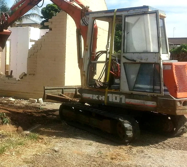 Mr Earthworx mini excavator on a demolition job site